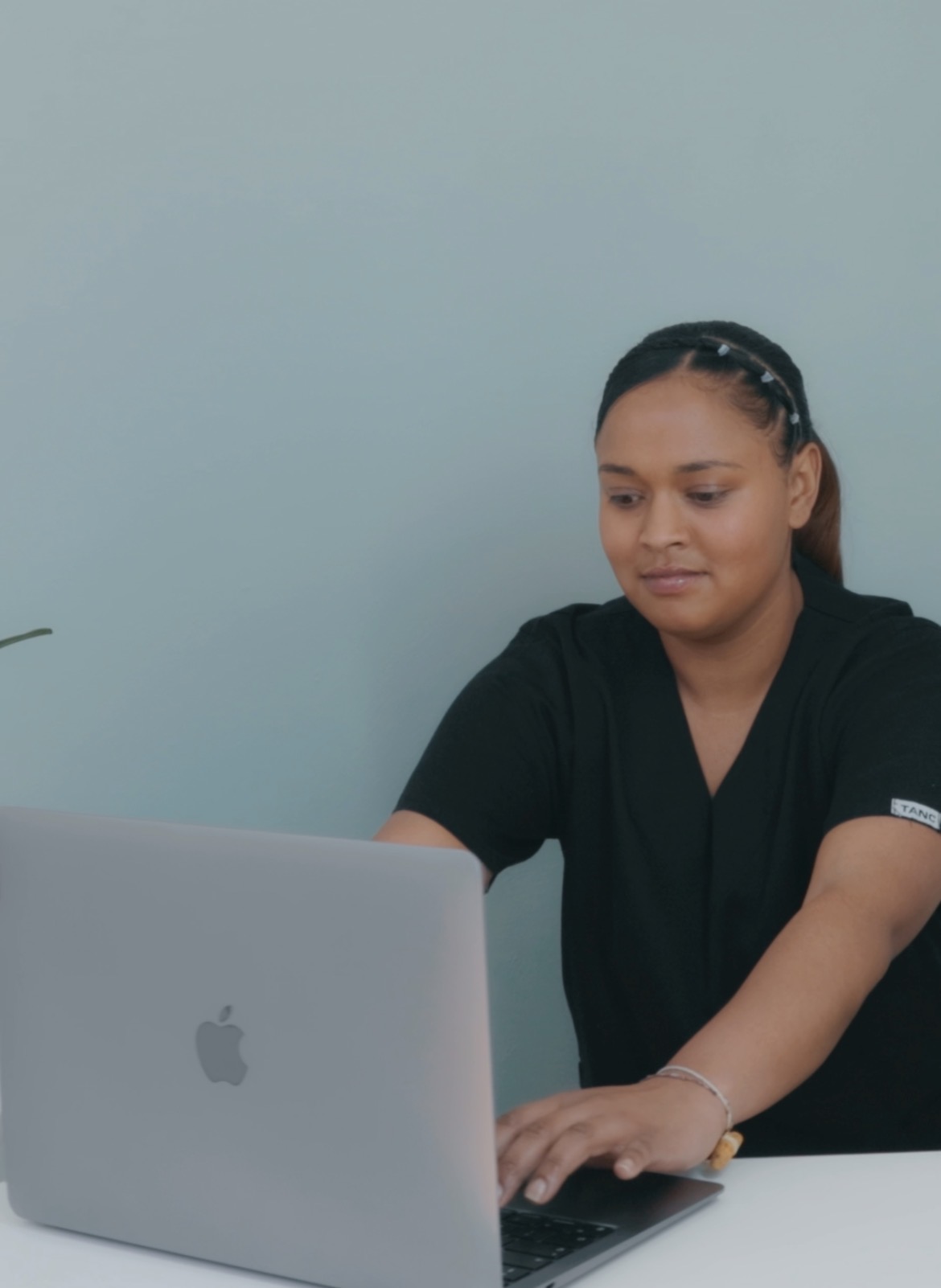 A member of the Avela Medical Practice team welcoming patients at the front desk